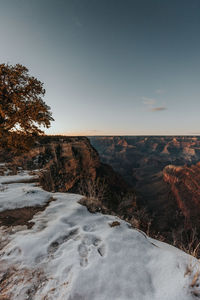 Scenic view of landscape against clear sky during winter