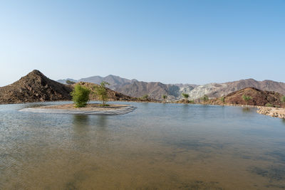 Scenic view of mountains against clear blue sky