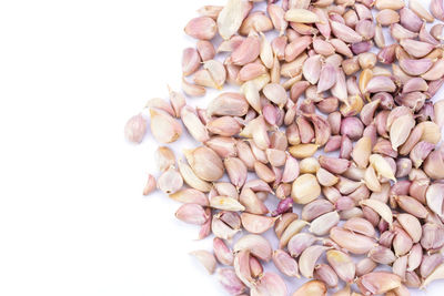 High angle view of chopped coffee beans against white background