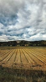 Scenic view of landscape against cloudy sky