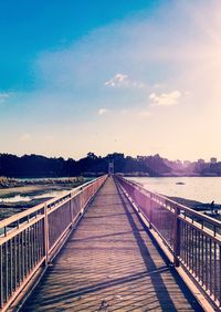 Surface level of footbridge against sky