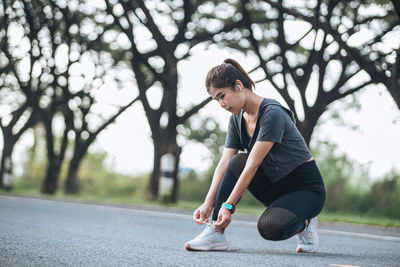 Young woman exercising on road