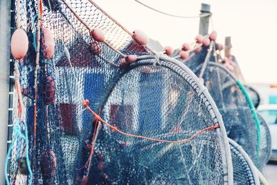 Close-up of fishing net against sky