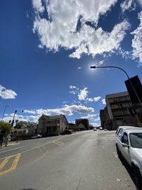 Street amidst buildings in city against sky