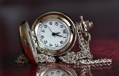 Close-up of pocket watch on table