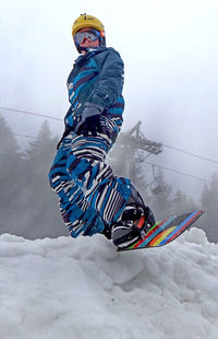 Low angle view of person snowboarding during foggy weather