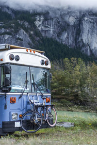 School bus converted parked front of squamish chief mountain granite