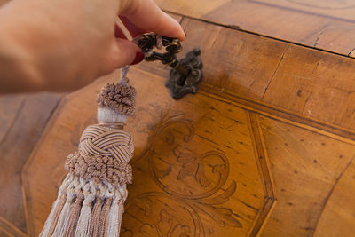 Cropped hand of woman opening wooden chest