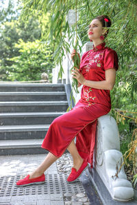 Portrait of young woman sitting on staircase