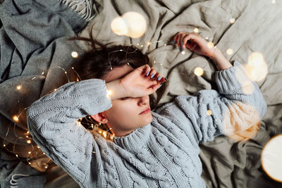 High angle view of siblings sleeping on bed at home