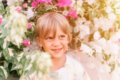 Portrait of face candid little happy smiling five year old blonde kid boy with green eyes