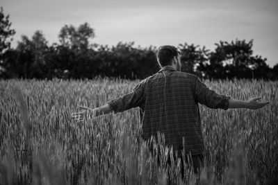 Rear view of man standing on field