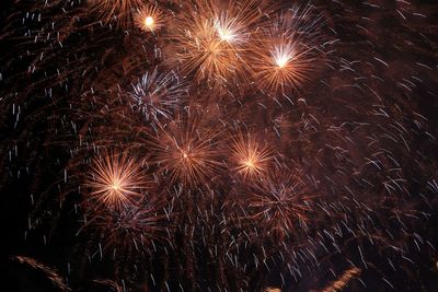 Low angle view of firework display at night