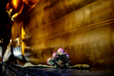 Close-up of flower statue on table in temple