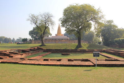 Built structure on field against sky