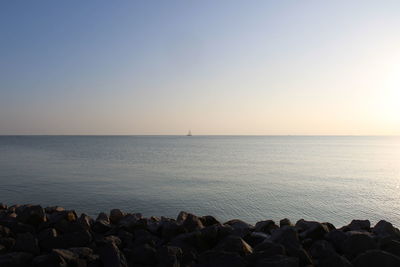 Scenic view of sea against clear sky at sunset