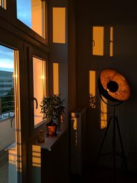 Illuminated lamp on table at home