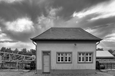 House by building against sky