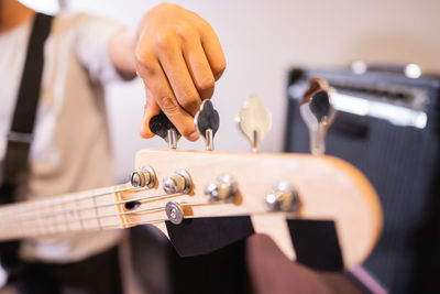 Midsection of person musician holding guitar