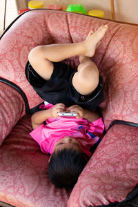 High angle view of women relaxing on bed