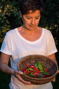 Adult woman enjoys for habanero red chilli peppers and cayenne p