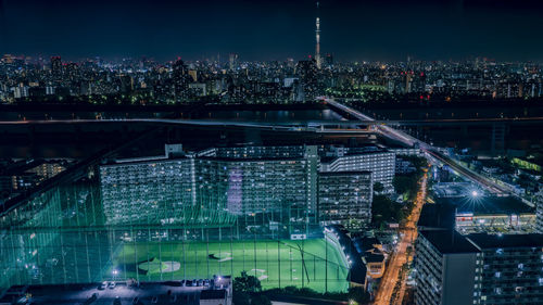 Aerial view of illuminated buildings in city at night