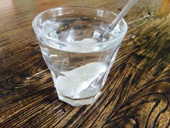 Glass of water on wooden table