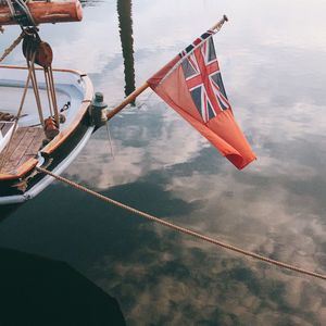 Low angle view of flag on boat against sky