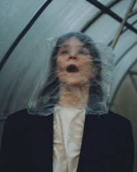 Close-up of woman wearing plastic bag on face