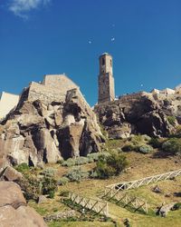 Old ruins on landscape against clear sky