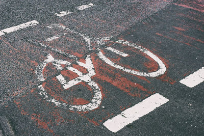 High angle view of arrow symbol on road