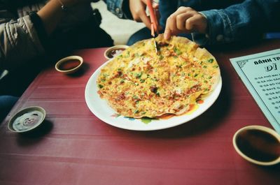 Cropped image of hand holding food