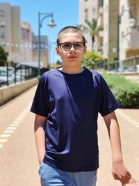 Portrait of young man standing in city