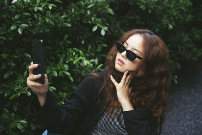 Young woman using mobile phone outdoors