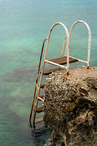 High angle view of ladder by swimming pool