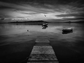 Pier on lake against sky