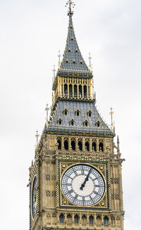 Low angle view of clock tower against sky