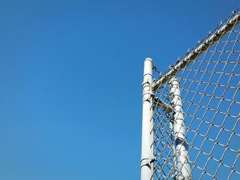 Low angle view of communications tower against blue sky