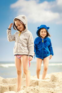 Siblings standing at beach