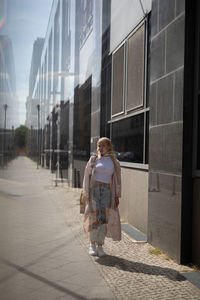 Multiple image of woman walking on road in city