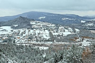 High angle view of townscape and mountains against sky