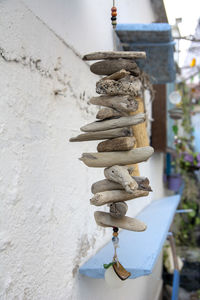 Low angle view of chain hanging against wall