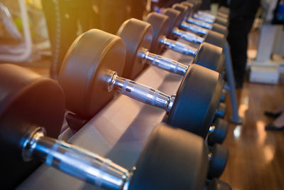 Close-up of dumbbells on rack in gym