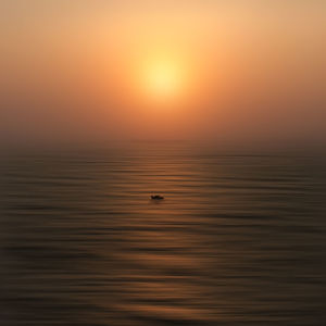 Scenic view of sea against orange sky