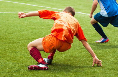 People playing soccer on field