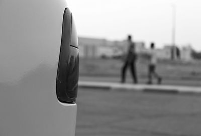 Close-up of airplane on airport runway against sky