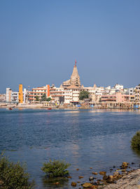 View of buildings and city against blue sky