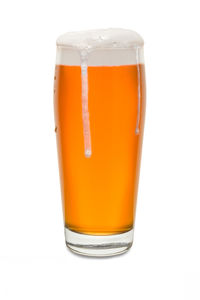 Close-up of beer glass against white background