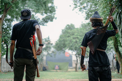 Rear view of couple standing on field