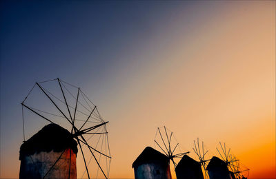Silhouette traditional windmill against sky at sunset
